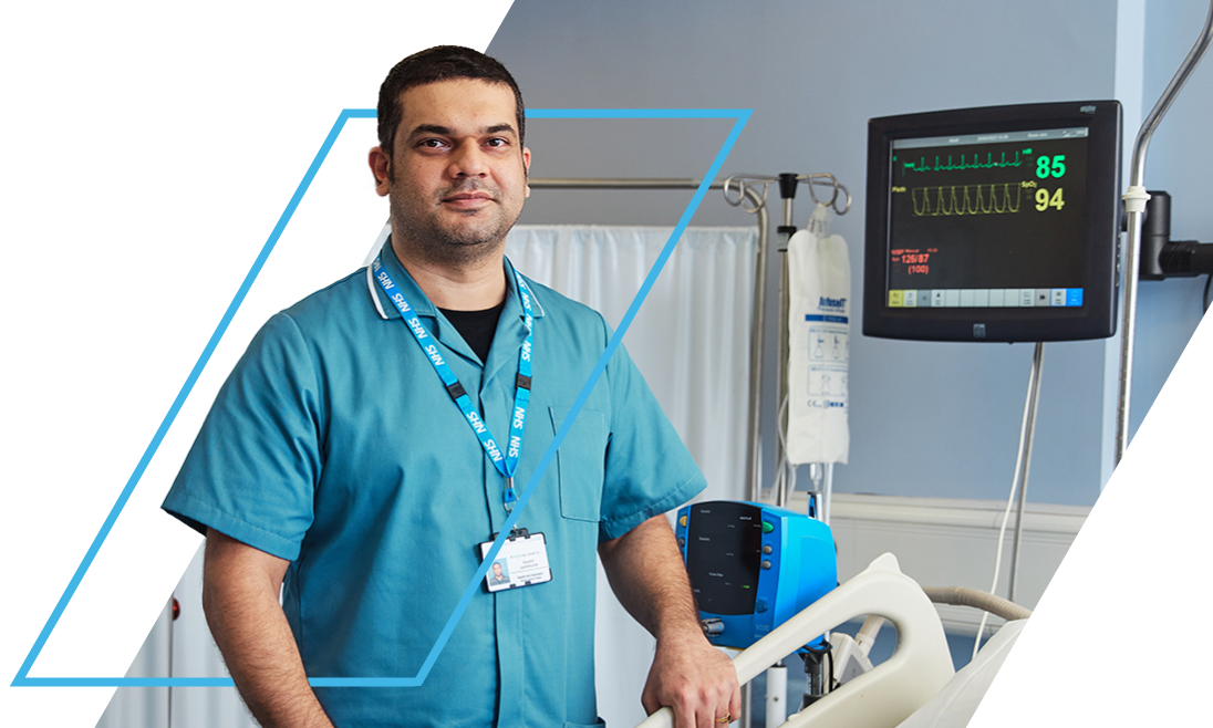 NHS Professionals Bank Member standing beside a hospital bed